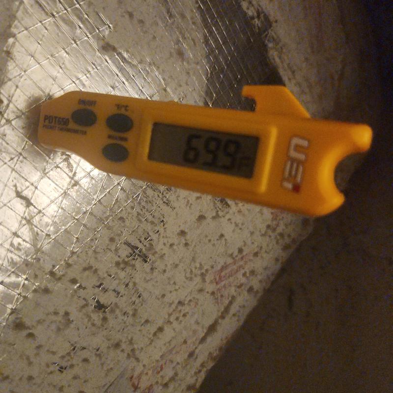 Digital pocket thermometer reading 69.9°F on foil surface