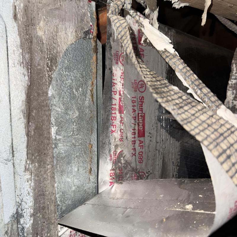 HVAC ductwork inside wall with torn insulation HVAC ductwork inside wall with torn insulation