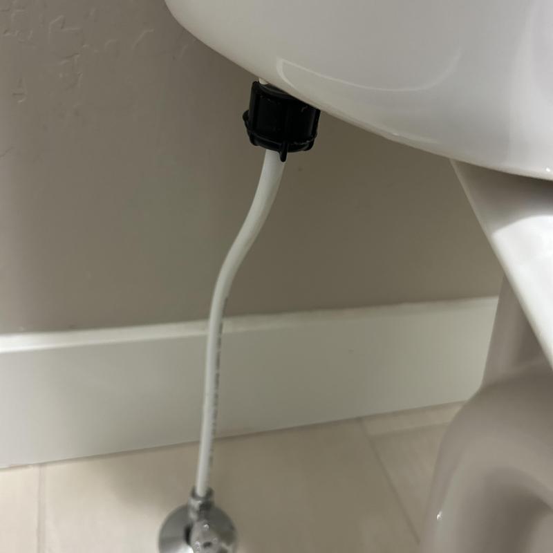 Toilet supply line connection under toilet bowl