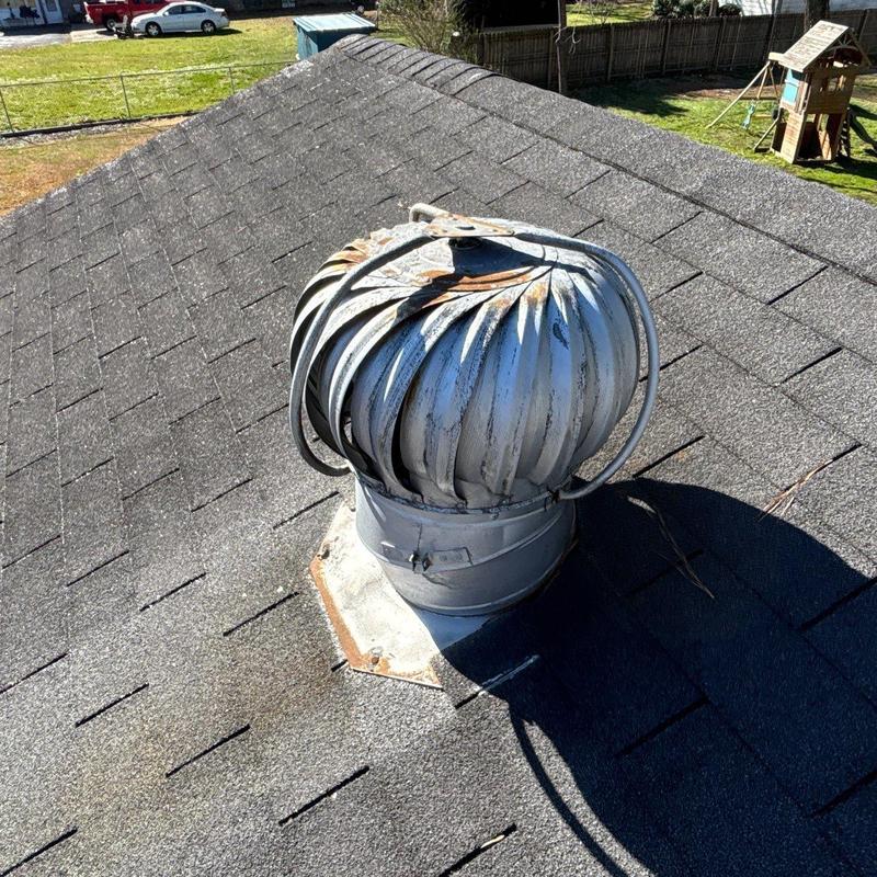 Roof turbine vent with rust on shingle roof