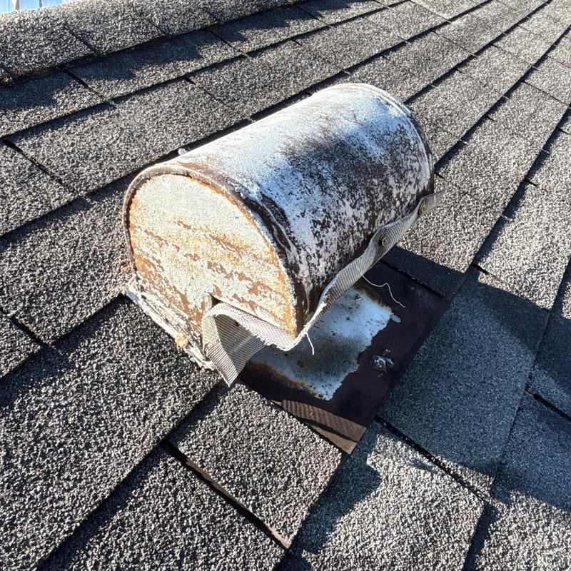 Roof vent rust and shingle deterioration on asphalt roof