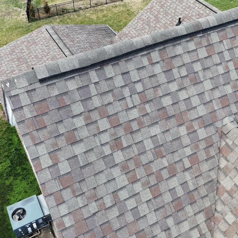 Asphalt shingle roof with hail damage inspection