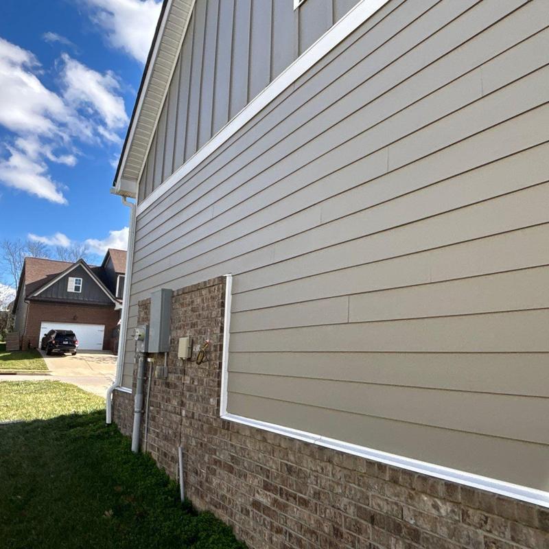 Vinyl siding and brick exterior with utility boxes