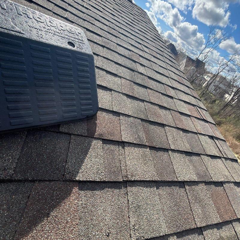 Asphalt shingle roof with hail damage inspection