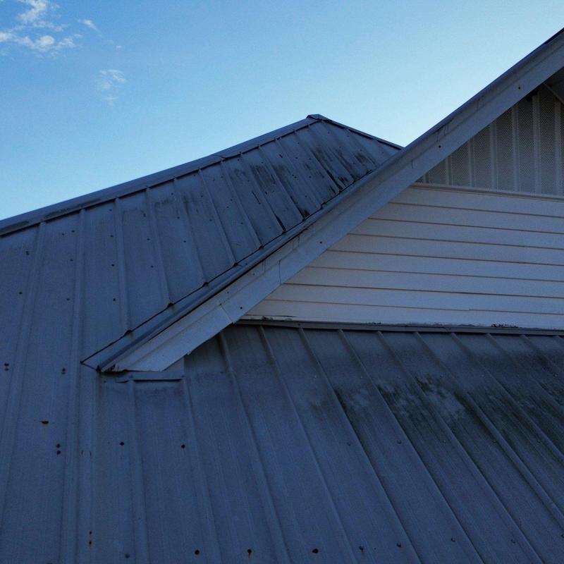 Metal roofing panels with hail damage and discoloration