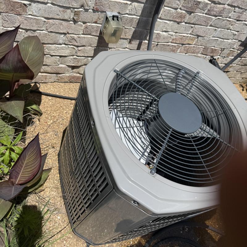 Air conditioner condenser unit outside brick wall Air conditioner condenser unit outside brick wall