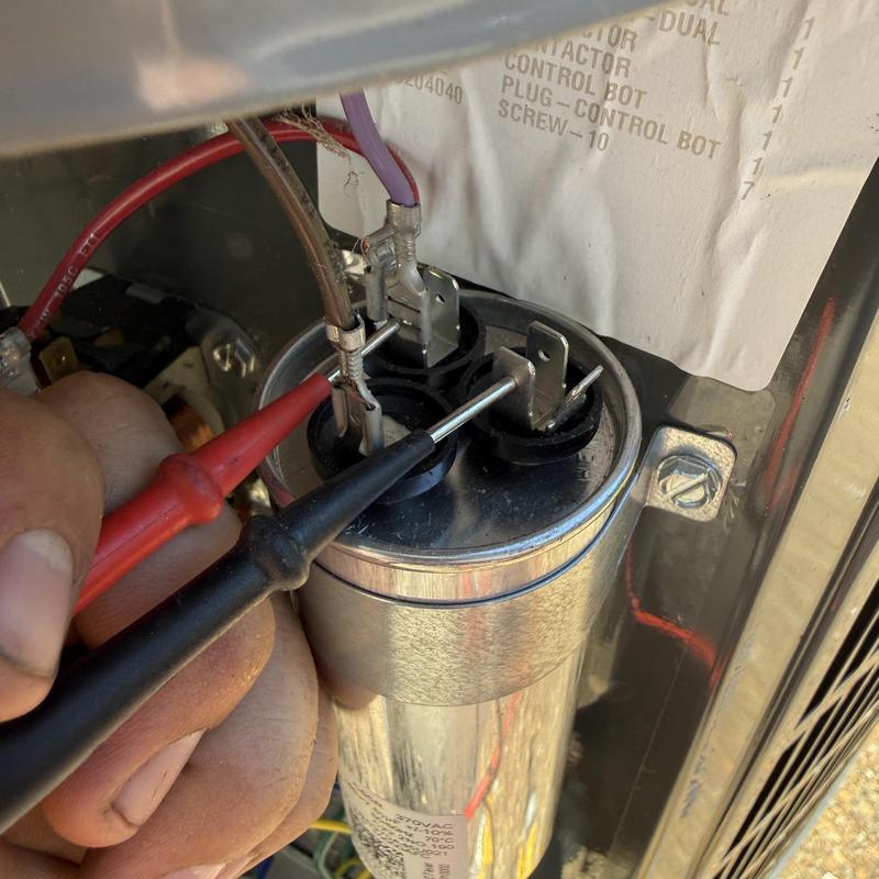HVAC capacitor testing with multimeter probes in unit HVAC capacitor testing with multimeter probes in unit