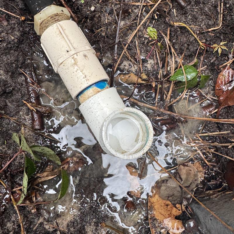 AC drain line with water leakage on wet soil AC drain line with water leakage on wet soil
