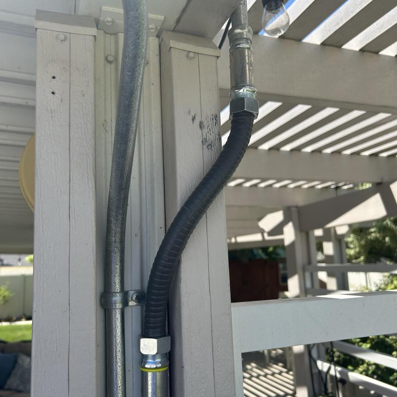 Liquid metallic flexible conduit installation on pergola post Liquid metallic flexible conduit installation on pergola post