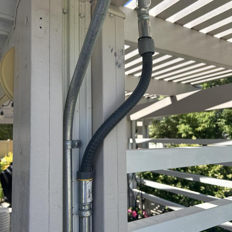 Liquid metallic flexible conduit installation on patio post Liquid metallic flexible conduit installation on patio post