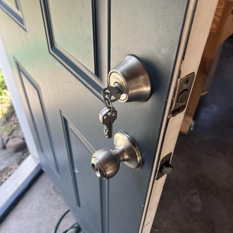 Deadbolt lock and door knob with keys in lock Deadbolt lock and door knob with keys in lock