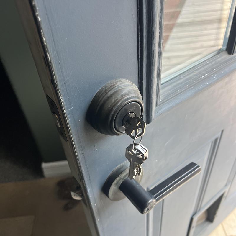 Deadbolt lock with keys in blue house door Deadbolt lock with keys in blue house door
