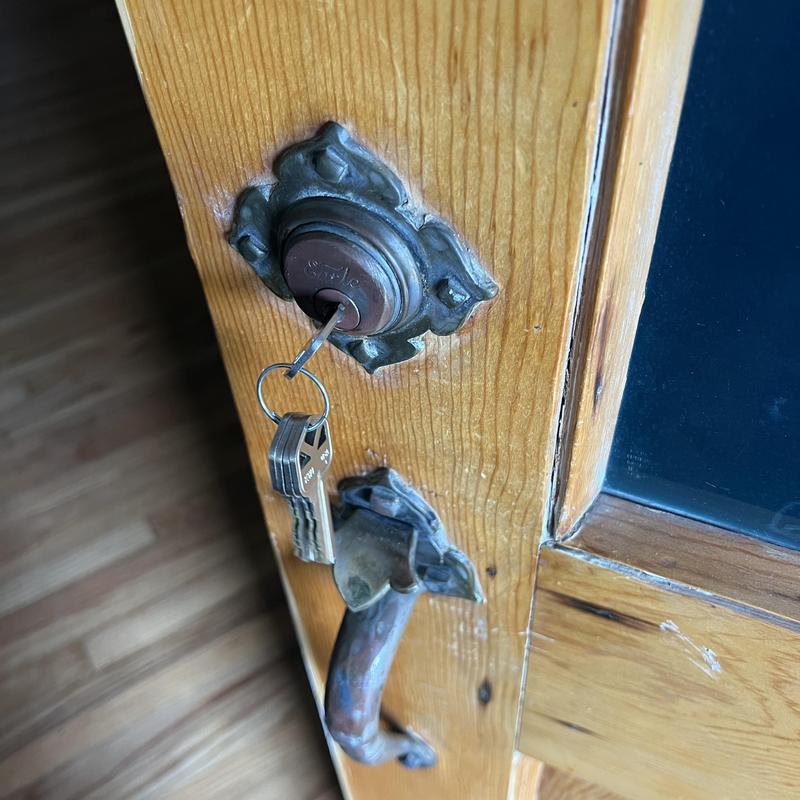 Deadbolt lock with key in wooden door Deadbolt lock with key in wooden door