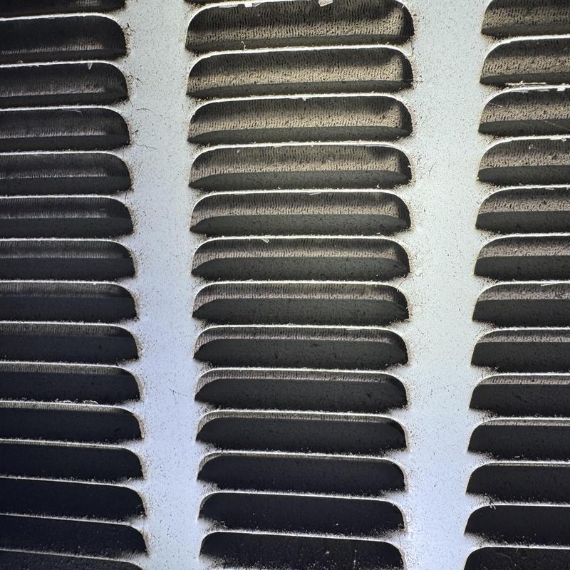 Condenser coil with restricted airflow and dust buildup Condenser coil with restricted airflow and dust buildup