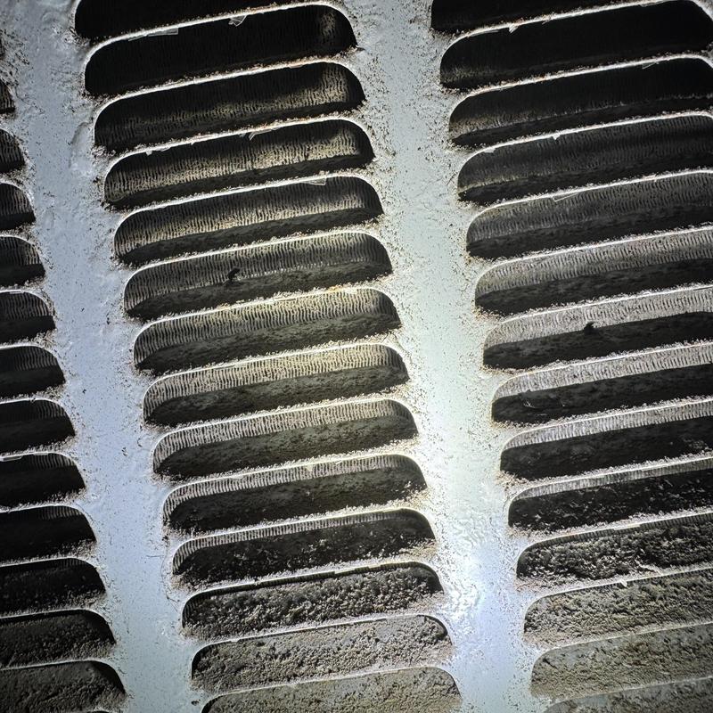 Condenser coil with heavy dirt buildup on fins Condenser coil with heavy dirt buildup on fins
