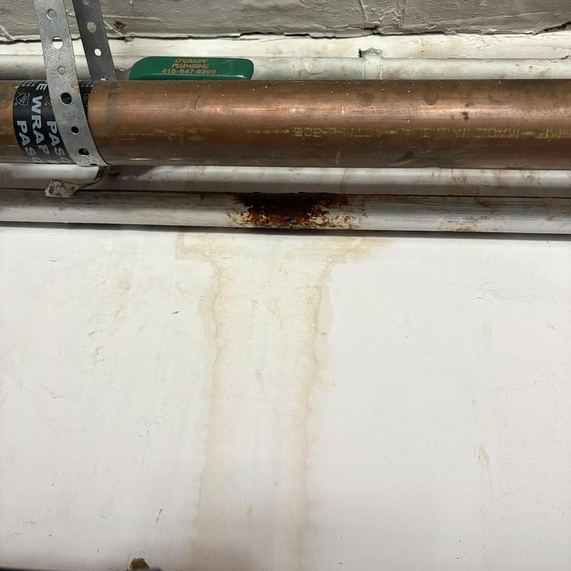 Copper water line with rust and leak stains