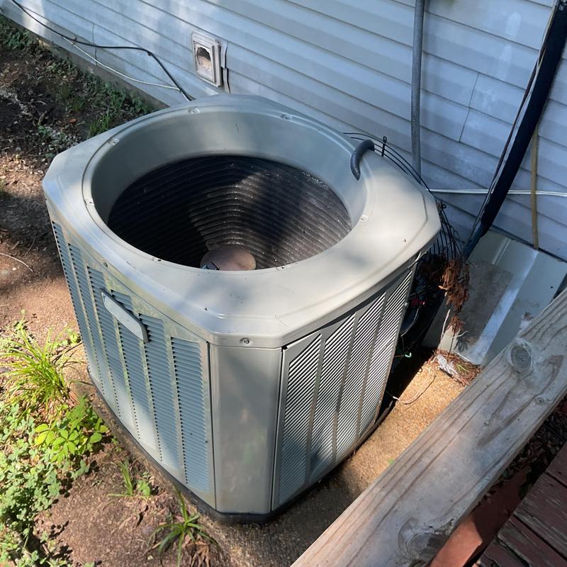 AC condenser unit missing compressor and cover outdoors AC condenser unit missing compressor and cover outdoors