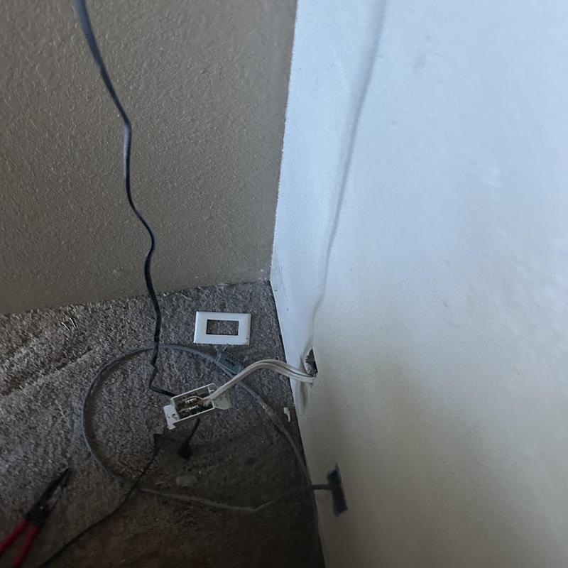 Electrical receptacle removed from wall with exposed wiring