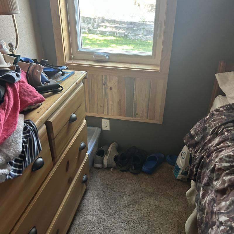 Electrical outlet under window in bedroom corner