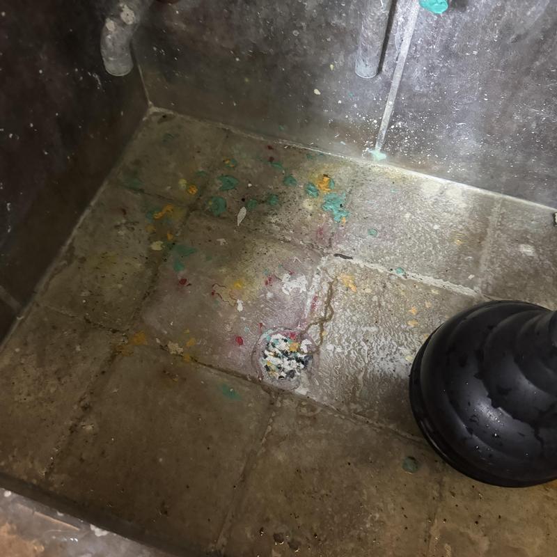 Mop sink drain with plunger and paint stains