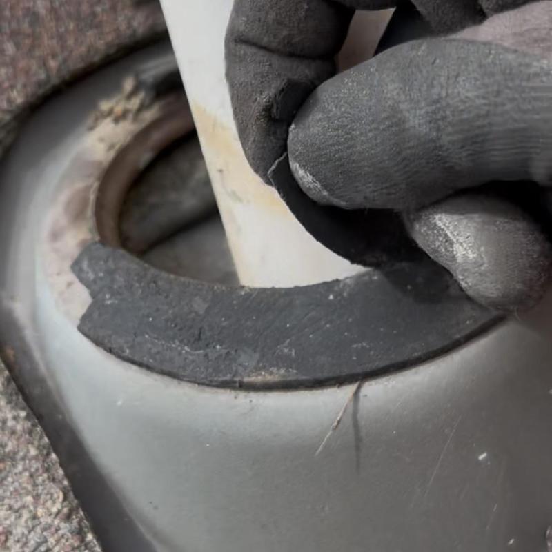 Pipe boot flashing showing wear on roof pipe seal Pipe boot flashing showing wear on roof pipe seal