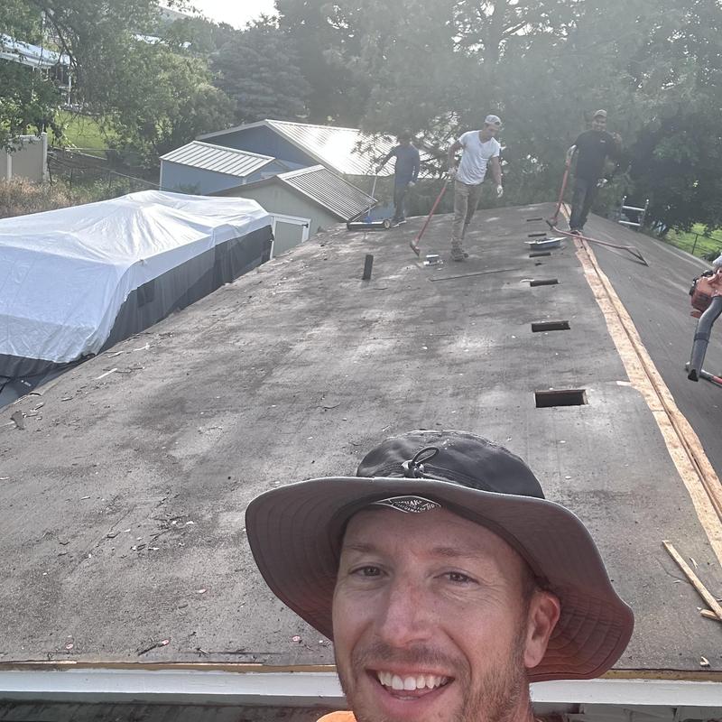 Roof decking tear off with workers using brooms Roof decking tear off with workers using brooms
