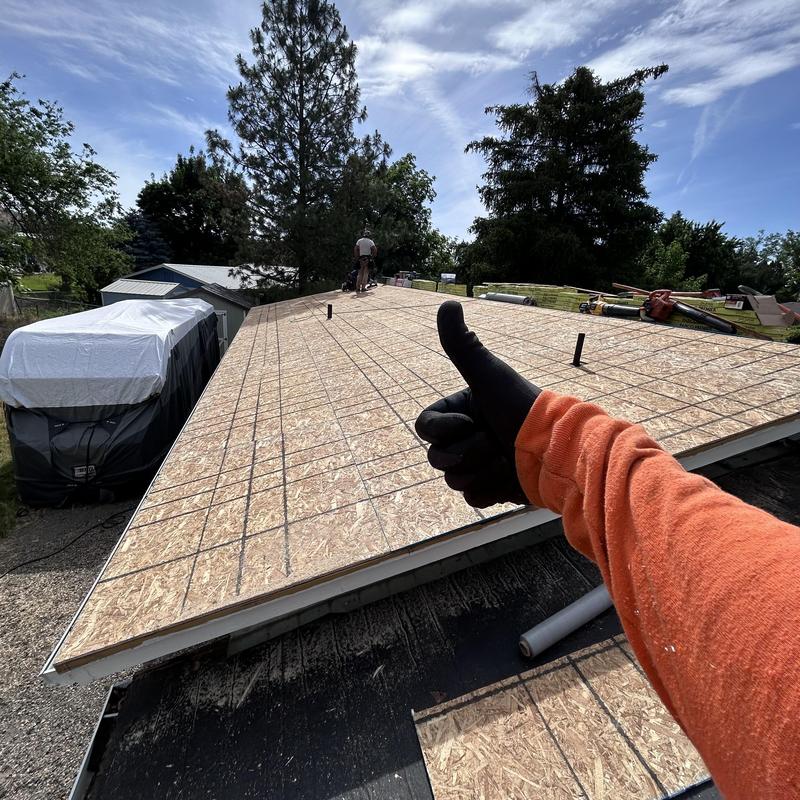 OSB roof decking installation with thumb up outdoors OSB roof decking installation with thumb up outdoors