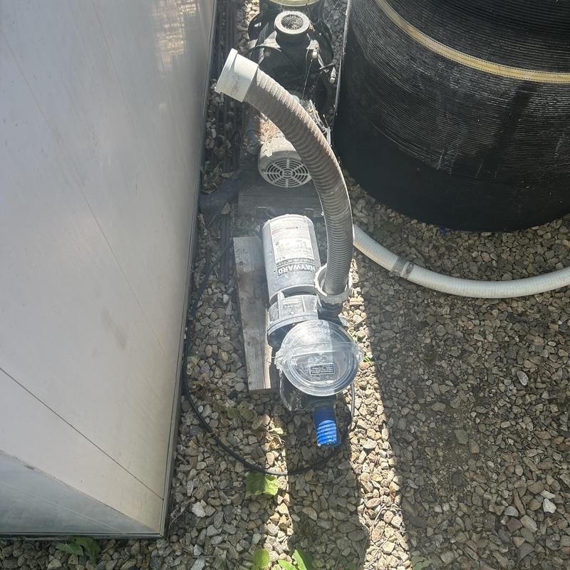 Pool pump with connected intake and discharge hoses Pool pump with connected intake and discharge hoses