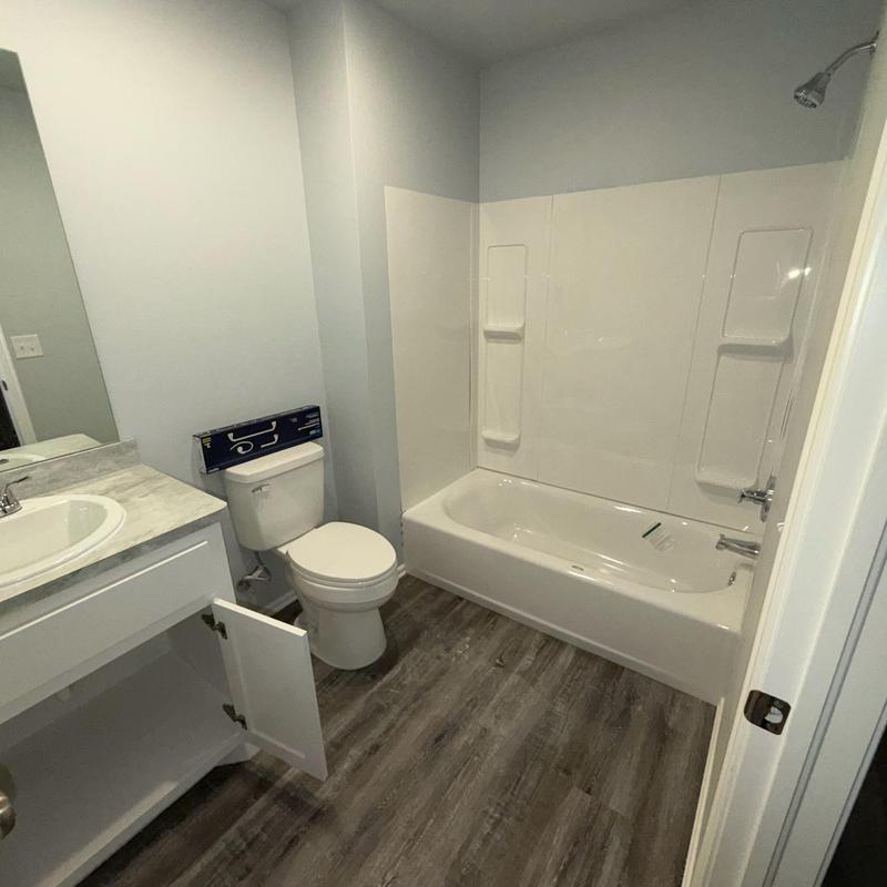 Bathtub and shower unit with new fixture installation Bathtub and shower unit with new fixture installation