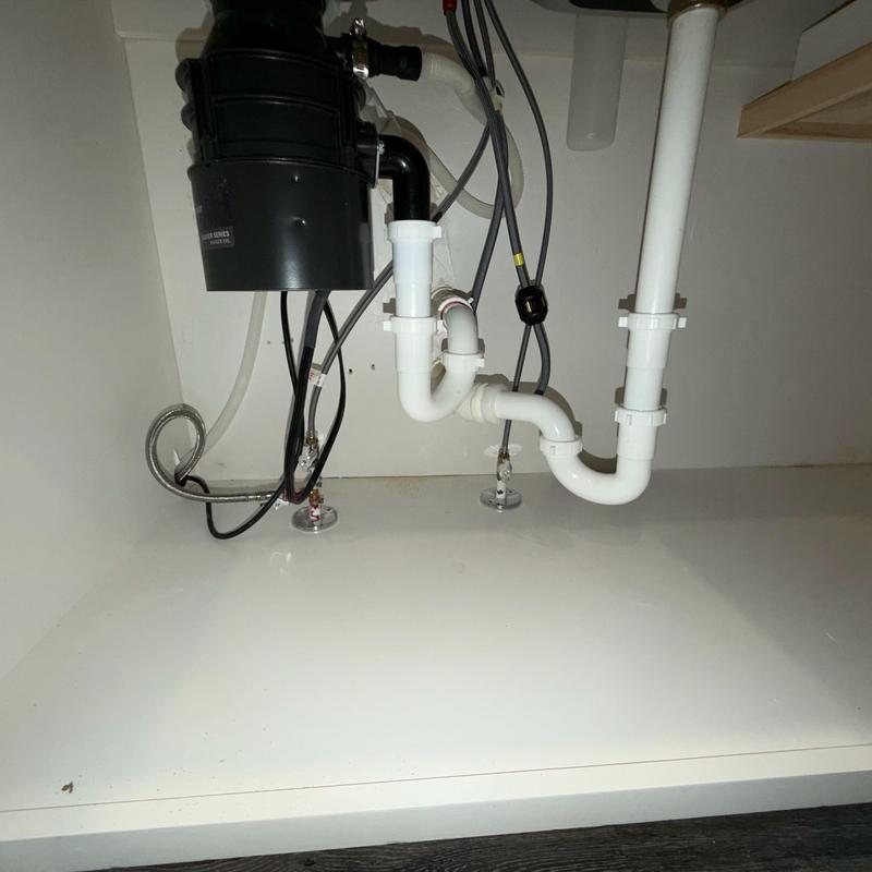 Garbage disposal and P-trap plumbing under sink Garbage disposal and P-trap plumbing under sink