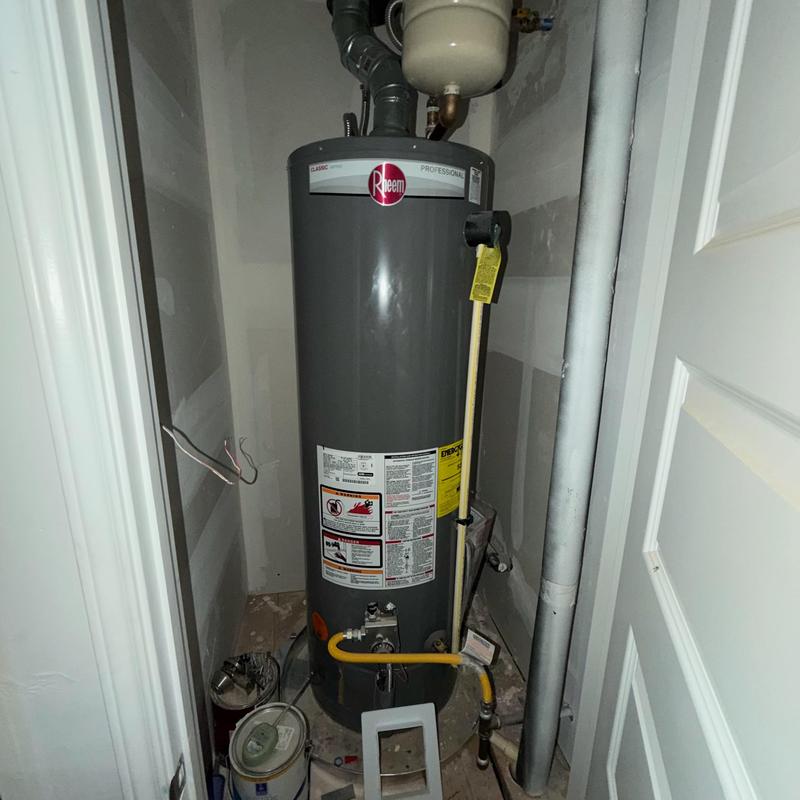 Hot water tank with code upgrade in utility closet Hot water tank with code upgrade in utility closet