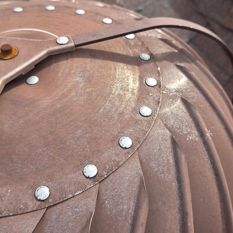 Metal roof turbine vent showing hail damage dents
