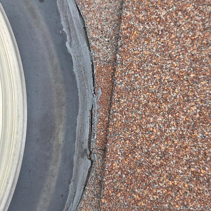 Roof shingle edges and flashing with hail damage
