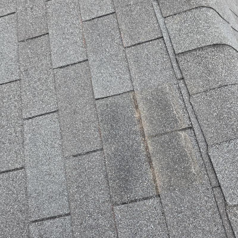 Three tab asphalt shingles with nail pops and sealed spots