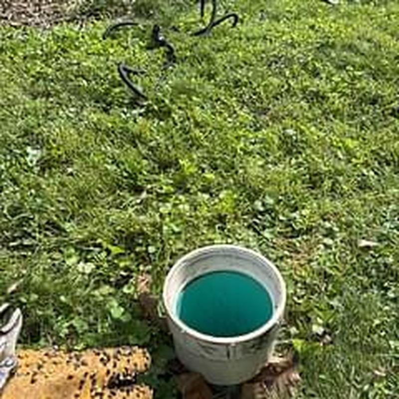 Main sewer line cleanout with plumbing tools outdoors