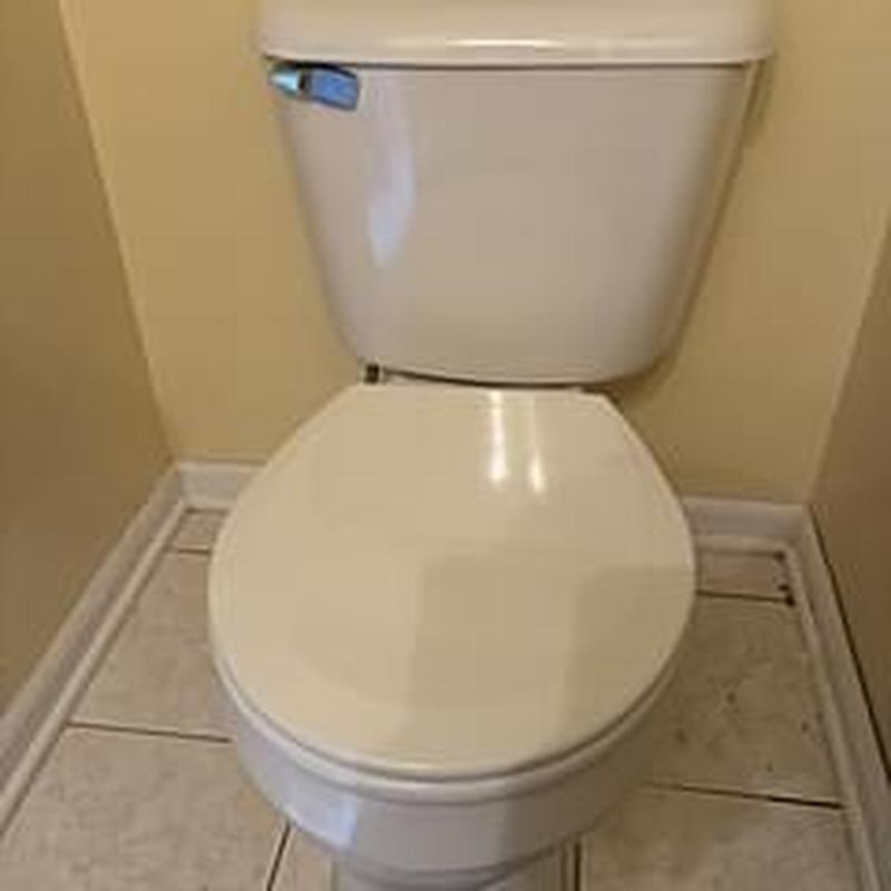 Mansfield round bowl toilet installed in bathroom corner