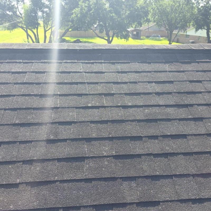 Asphalt shingle roof with hail impact and weathering