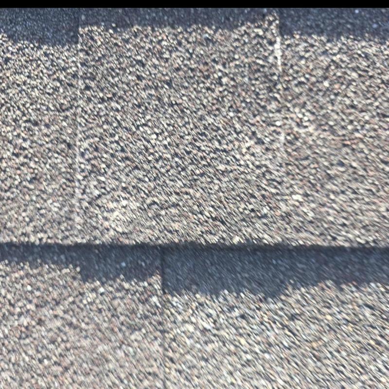 Asphalt shingles with hail impact damage close-up