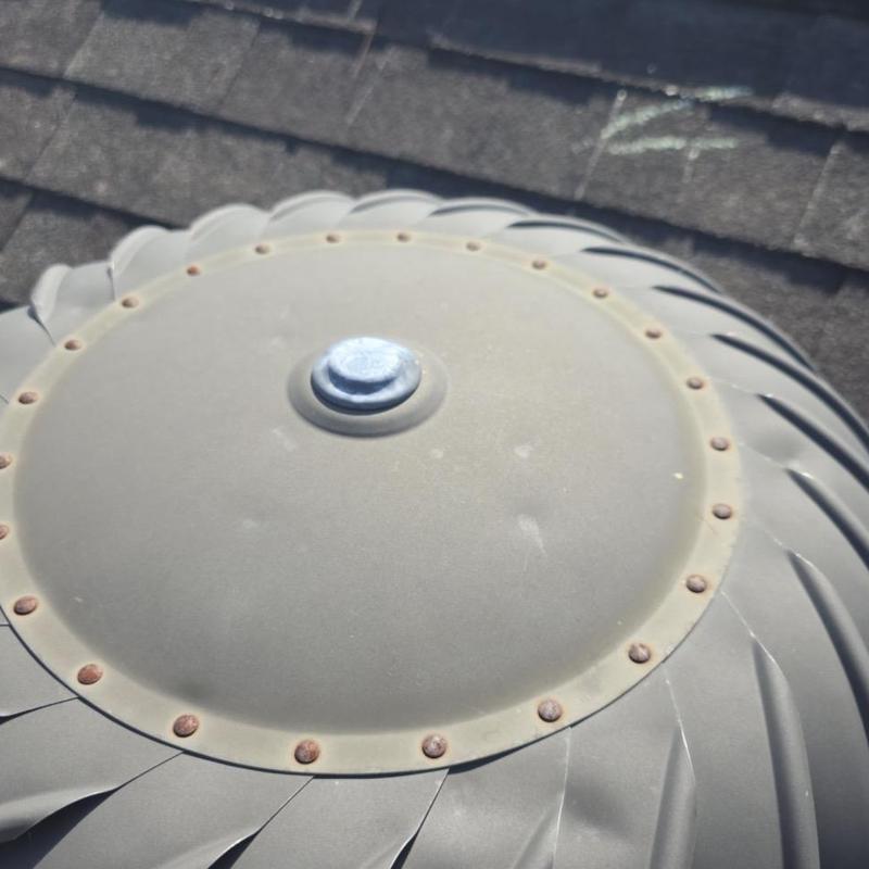 Roof turbine vent showing rusted screws and bolts