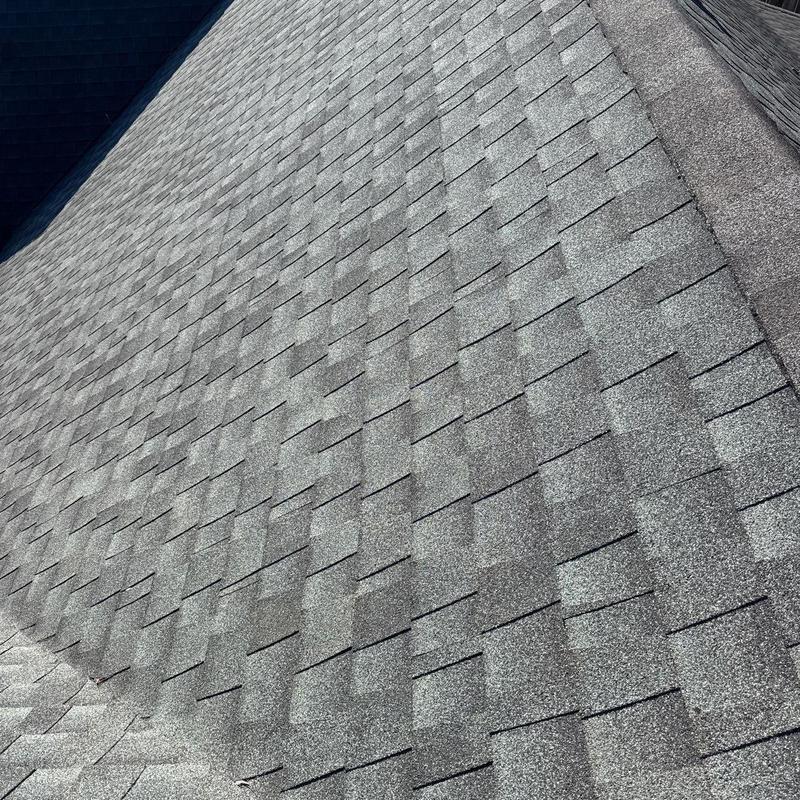 Asphalt shingle roof with visible hail damage and wear