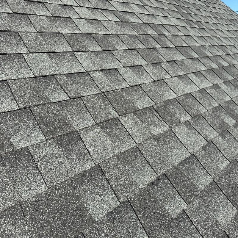 Asphalt shingles with hail damage on roof surface