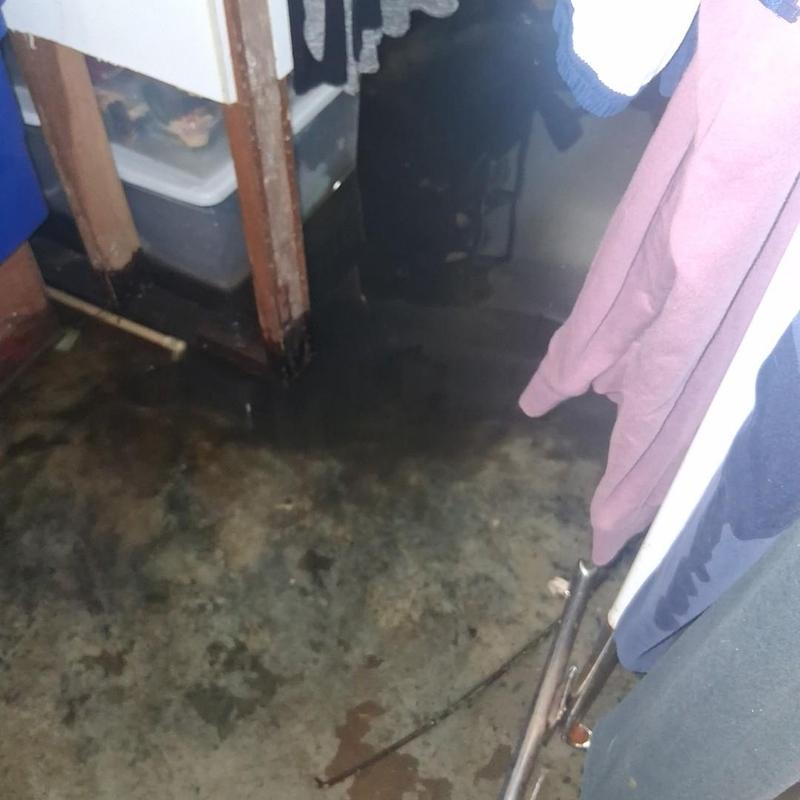 Basement floor flooding near closet with water damage