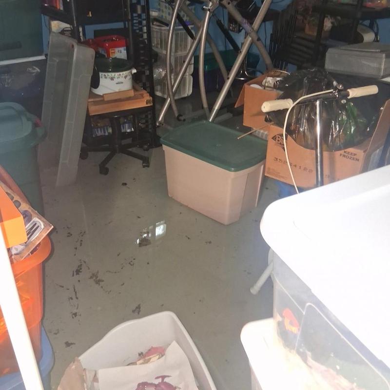 Basement floor flood with standing water and clutter