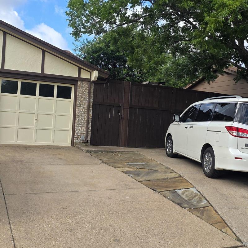 Driveway stone inlay and concrete surface near garage