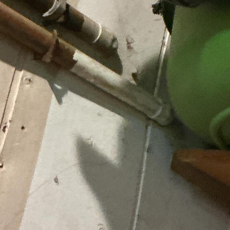 Drywall access hole cut near plumbing pipes