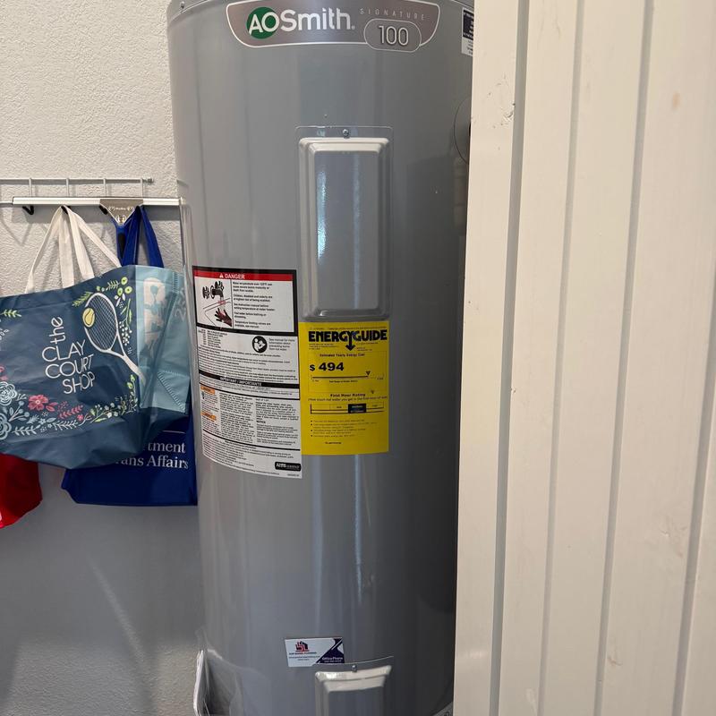 Electric water heater installed in home utility closet