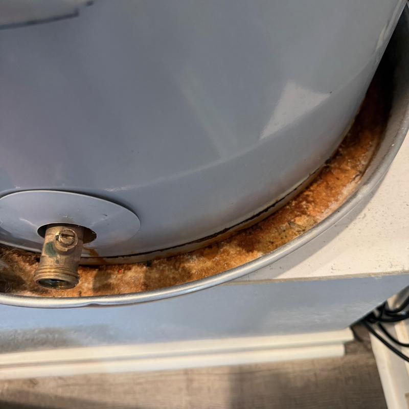 Water heater base with rust and corrosion buildup