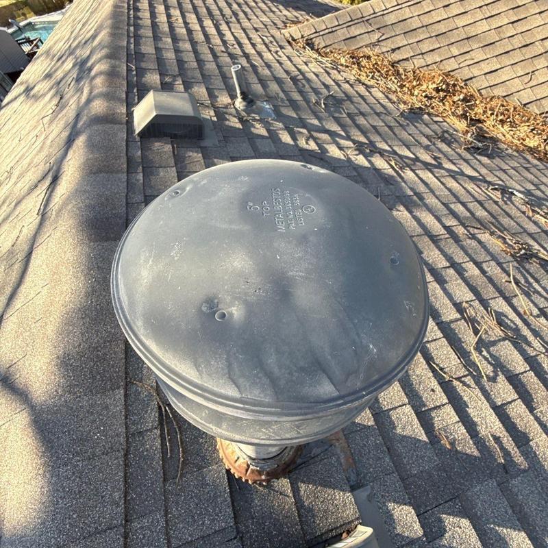 Roof vent with hail damage on asphalt shingles