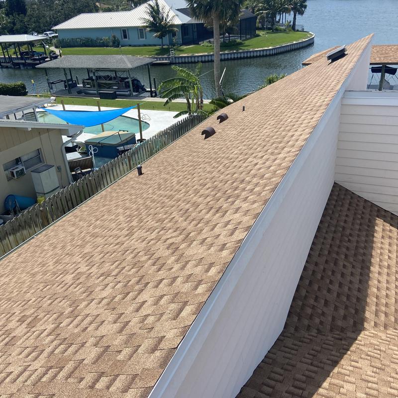 Architectural shingle roof with solar vents on canal home Architectural shingle roof with solar vents on canal home