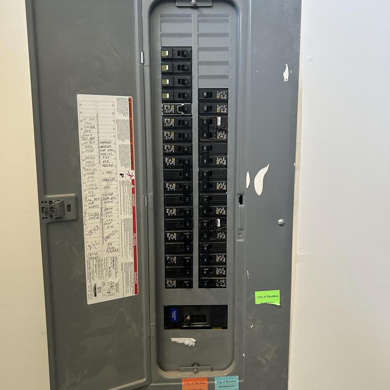 Electrical breaker panel with labeled circuits inside